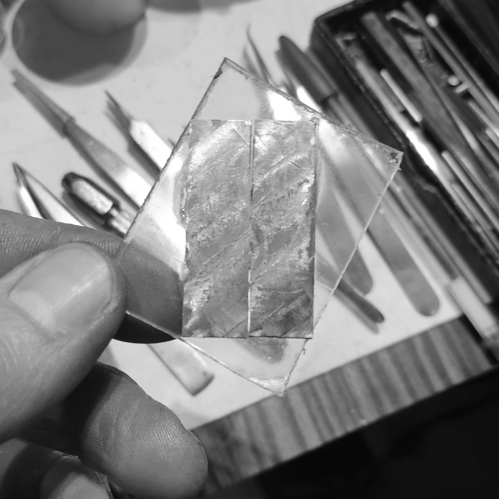 I cemented the pieces on a piece of acrylic. Acrylic and contact cement is widely used in the watch industry for work holding, as it bonds very well with steel, and acetone can then easily dissolve it.