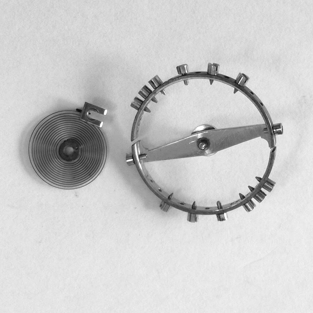Hairspring removed. This balance also shows a replacement staff with the brass bushing.