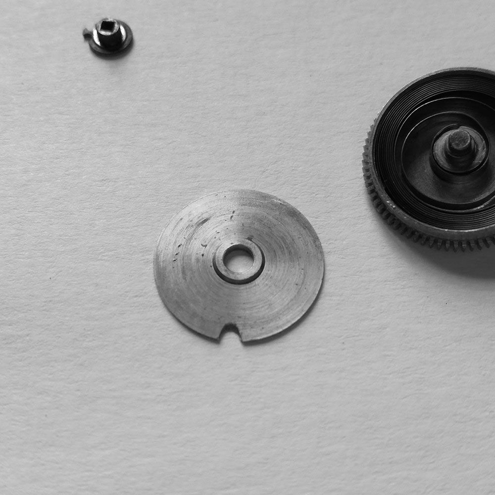 Inside of the top main spring barrel (this portion faces the dial).