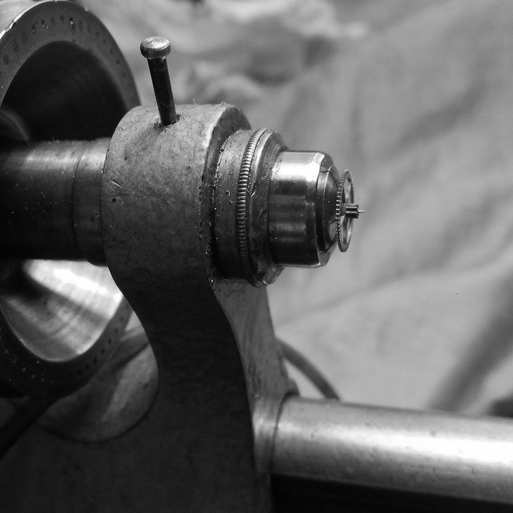 The back of the pinion is held in the chuck, and polished with the pivot polisher charged with diamond paste.